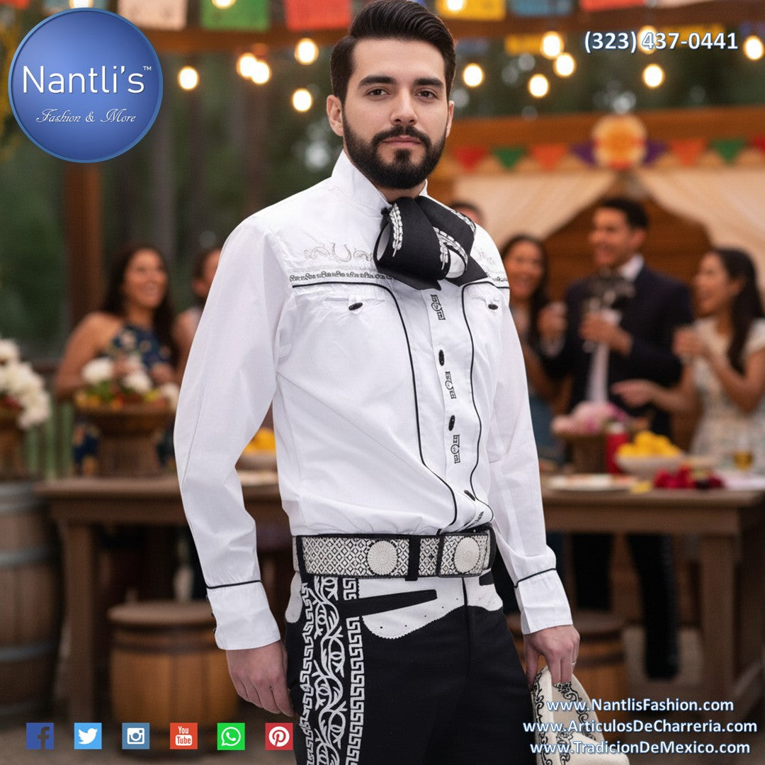 Camisa Charra Camisa de Charro Shirt Man wearing a traditional outfit with a blurred background of people and decor.